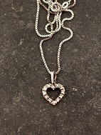 14 carat white gold heart pendant with several diamonds