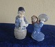 Royal Copenhagen Denmark, pair of figurines Nos 3677 Girl with pot lid and No 3689, Boy with horn
