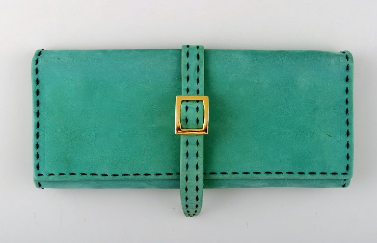 Georg Jensen jewelry purse in green leather with golden logo.
