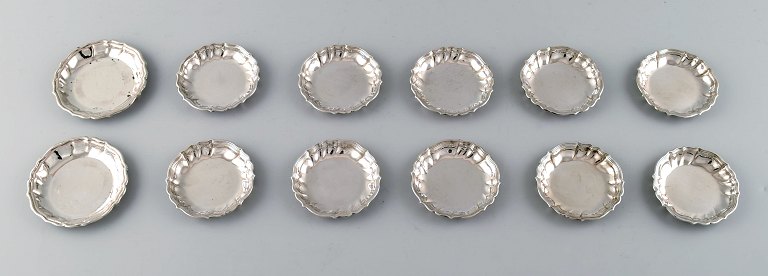 Twelve Cohr, large bottle trays in silver .830.