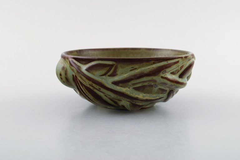 Axel Salto for Royal Copenhagen: Stoneware bowl modeled in organic shape, 
decorated with glaze in earth tones.  1940