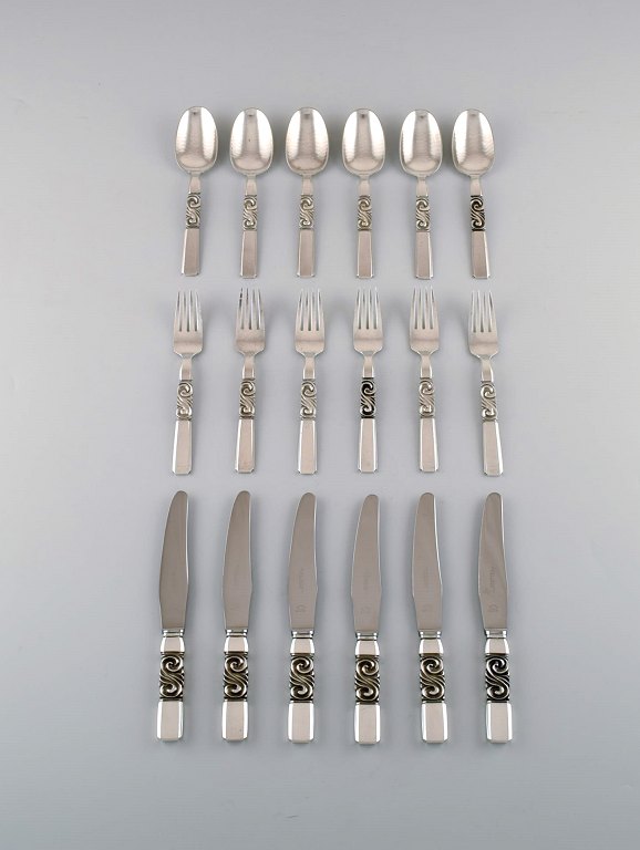 Georg Jensen. Cutlery, Scroll No. 22, Complete lunch service of hammered 
sterling silver.