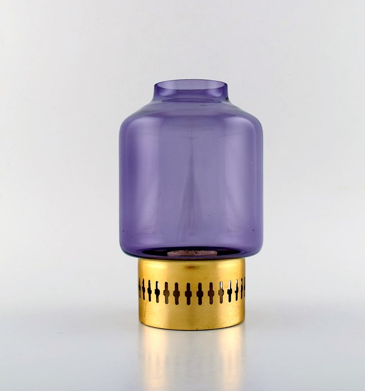 HANS-AGNE JAKOBSSON for A / B MARKARYD. Candle holder in brass and purple art 
glass. Ca. 1970.