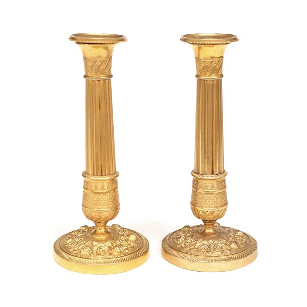 A pair of small gilt bronze candlesticks. France circa 1820. H: 19cm