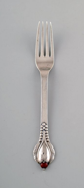 Evald Nielsen number 3, dinner fork in hammered silver (830) with cabochon coral 
bead. 1920