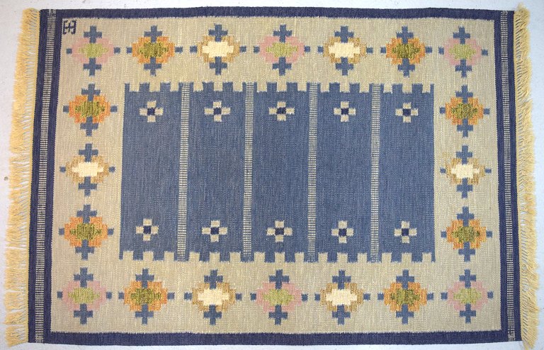 Elsa Ekholm, Sweden. Hand-woven rug of wool in "rölakan" technique. Geometric 
fields in yellow, blue and white.