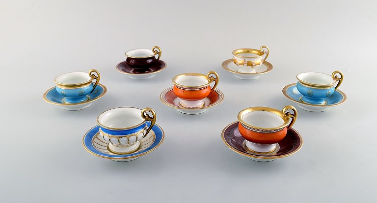 Royal Copenhagen. Seven empire mocha cups with saucers. Hand painted with gold 
leaf in overglaze. 1920