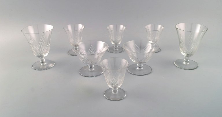 Saint-Louis, France. Eight sherry and wine glasses in clear mouth-blown crystal 
glass. 1930