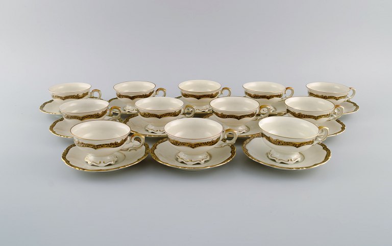 KPM, Berlin. Twelve Royal Ivory tea cups with saucers in cream-colored porcelain 
with gold decoration. 1920s.
