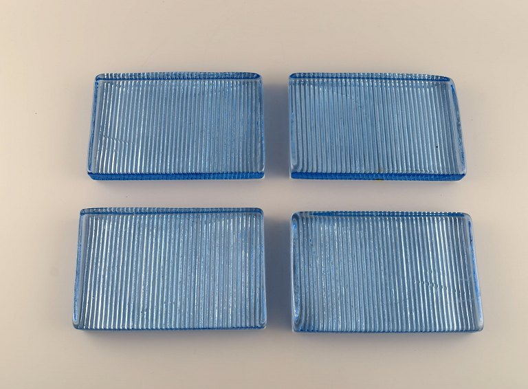 Per Lütken for Holmegaard. Four "Buffet" butter boards in light blue mouth blown 
art glass. 1980s.
