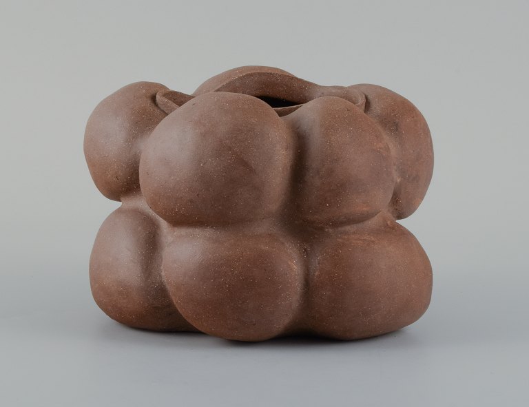 Christina Muff, Danish contemporary ceramicist (b. 1971). Dark brown unglazed vessel. Organic shaped vase with lips. Clear glaze inside.