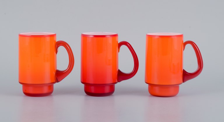 Michael Bang for Holmegaard.
Three mugs in orange and white art glass.
