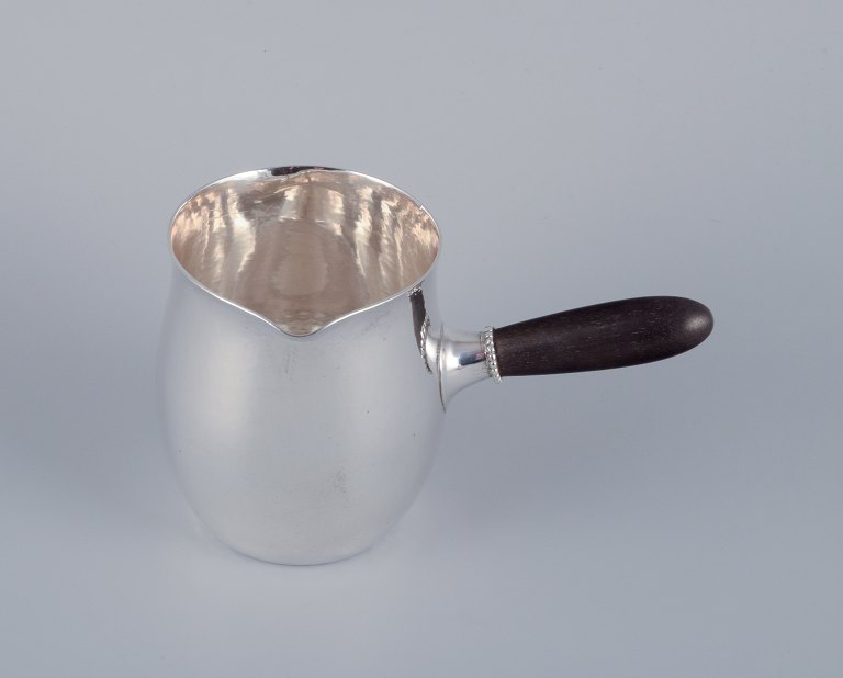 Georg Jensen pitcher in sterling silver with an ebony handle.