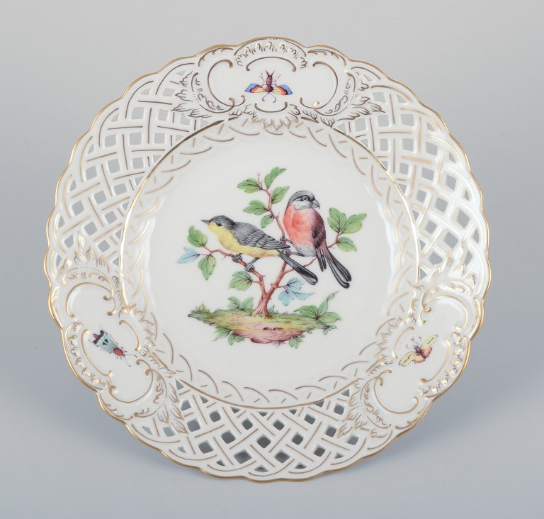 Meissen, Germany. Open lace porcelain plate. Hand-painted with a bird motif and 
insects, gold trim.