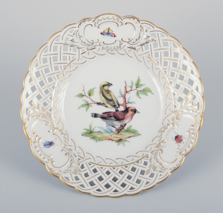 Meissen, Germany. Open lace porcelain plate. Hand-painted with a bird motif and 
insects, gold trim.