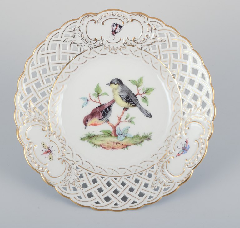 Meissen, Germany. Open lace porcelain plate. Hand-painted with a bird motif and 
insects, gold trim.