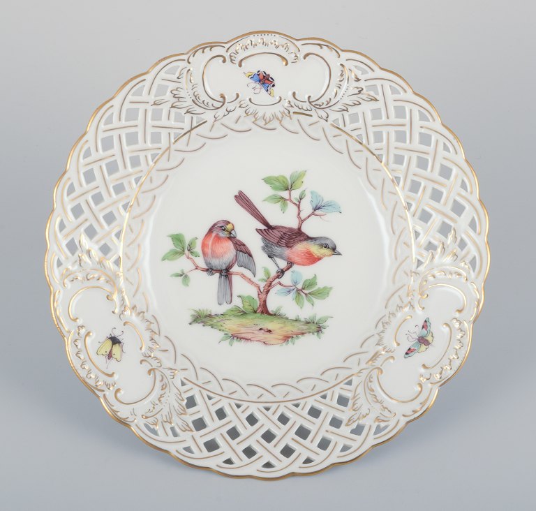 Meissen, Germany. Open lace porcelain plate. Hand-painted with a bird motif and 
insects, gold trim.