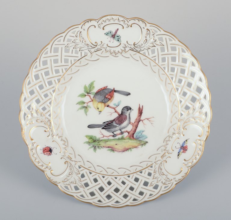 Meissen, Germany. Open lace porcelain plate. Hand-painted with a bird motif and 
insects, gold trim.