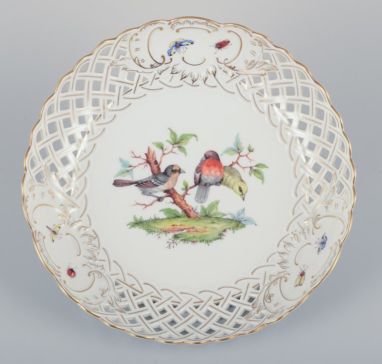 Meissen, Germany. Large open lace porcelain bowl. Hand-painted with a bird motif 
and insects, gold trim.