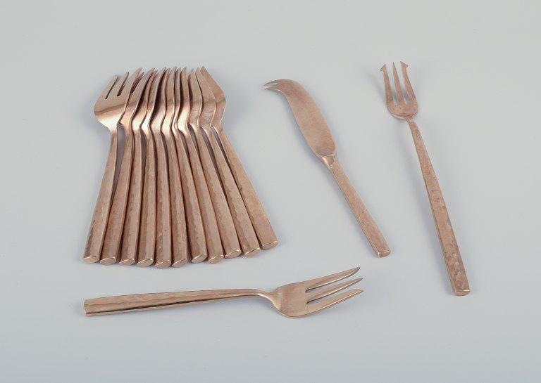 Scandinavian designer. Twelve-person cheese service in handcrafted hammered 
brass. High-quality craftsmanship.