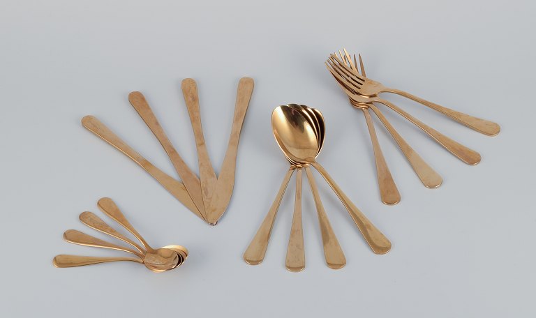Lagerhaus, Sweden. Dinner set in brushed brass for four people.