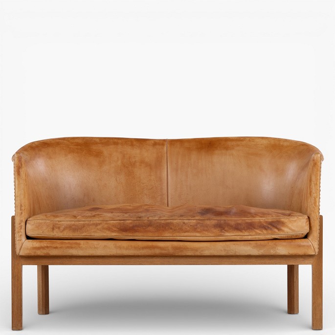 Mogens Koch / Rud. Rasmussen Snedkerier.MK 52/2 - 2-seater sofa in patinated, stitched natural leather with a mahogany frame.1 pc. in stock